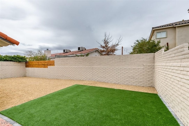 view of yard with a fenced backyard