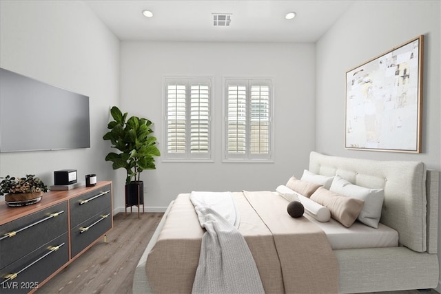 bedroom with baseboards, recessed lighting, visible vents, and light wood-style floors