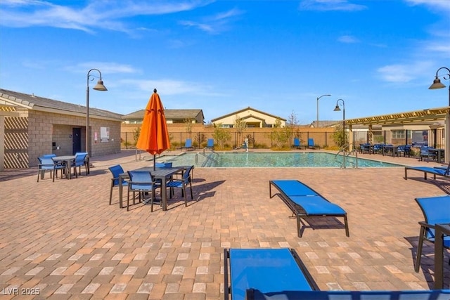 pool featuring a patio area, fence, and a pergola