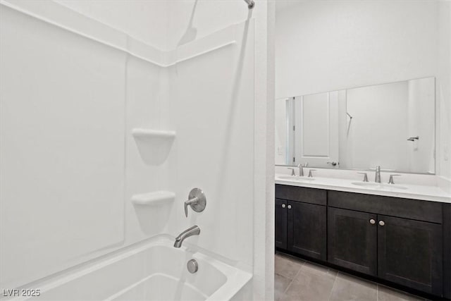 bathroom with bathtub / shower combination, a sink, and double vanity