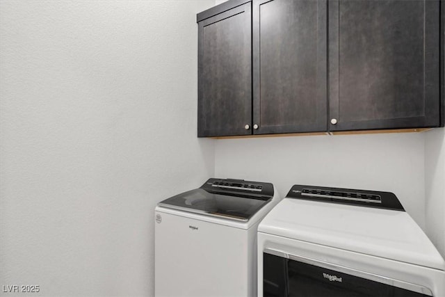 washroom featuring cabinet space and separate washer and dryer