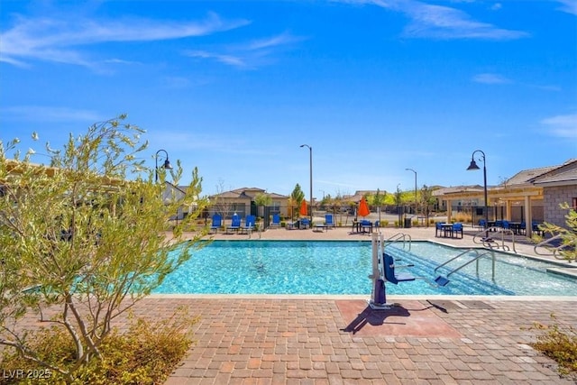 community pool featuring a patio and fence