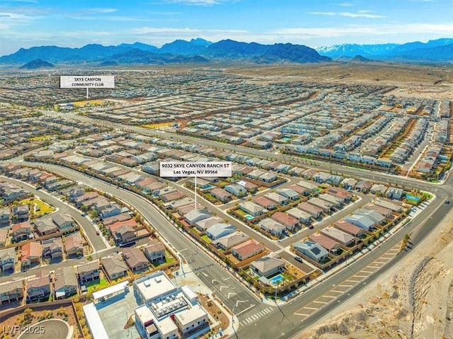 birds eye view of property featuring a mountain view