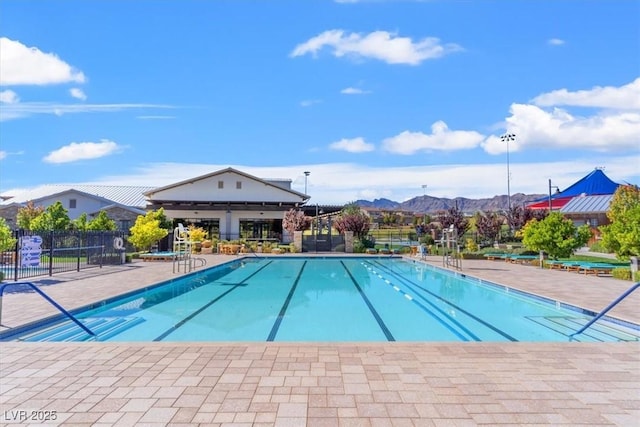 pool featuring fence and a mountain view