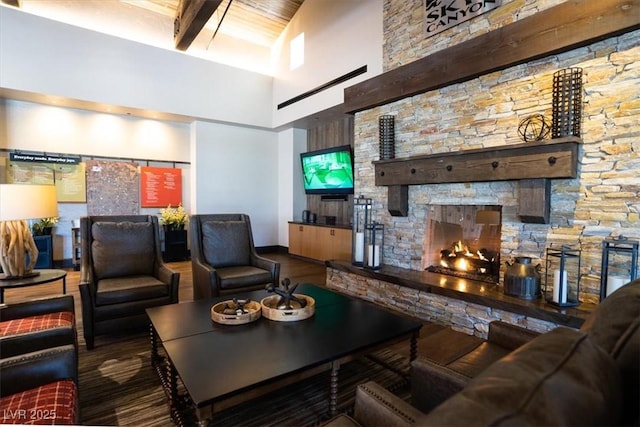 living room with a fireplace and a high ceiling