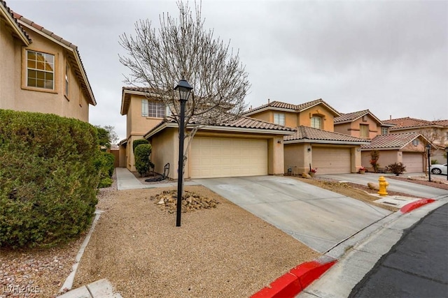 view of front of house with a garage, a tile roof, driveway, and stucco siding