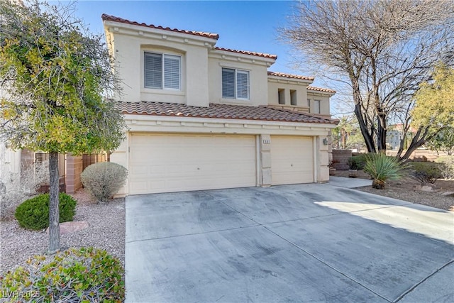 mediterranean / spanish home with an attached garage, a tile roof, concrete driveway, and stucco siding