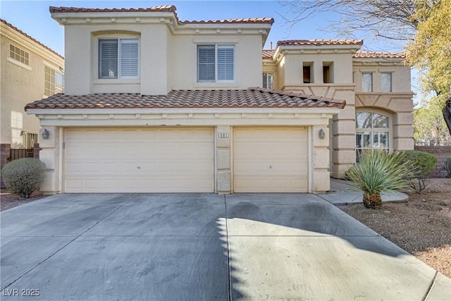 mediterranean / spanish house featuring a garage, driveway, a tiled roof, and stucco siding