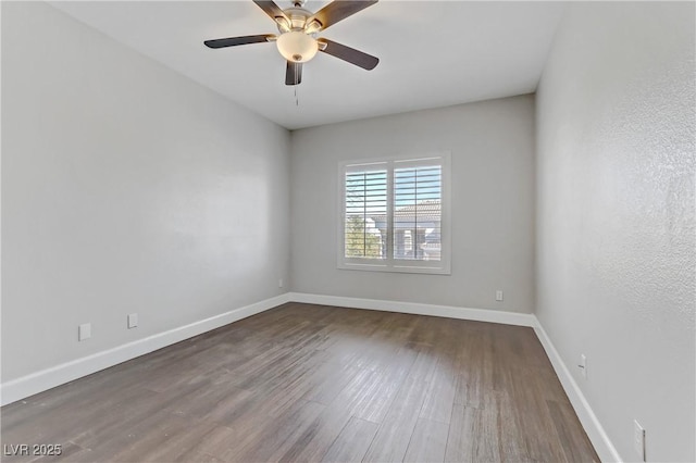 empty room featuring ceiling fan, baseboards, and wood finished floors