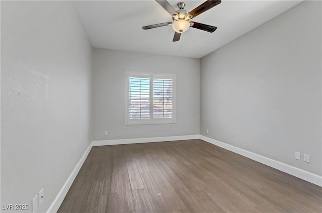 spare room featuring a ceiling fan, baseboards, and wood finished floors