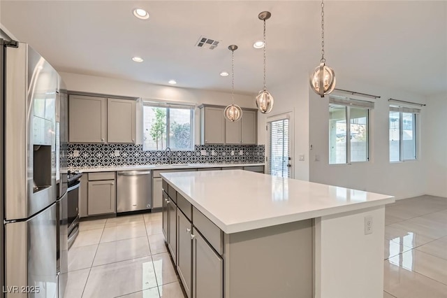 kitchen featuring appliances with stainless steel finishes, visible vents, and gray cabinetry