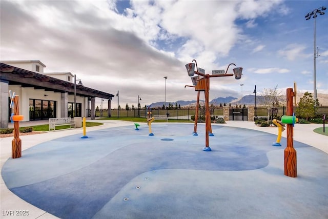 surrounding community featuring fence and a mountain view