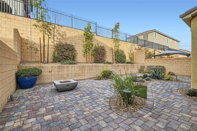 view of patio with a fenced backyard and a fire pit