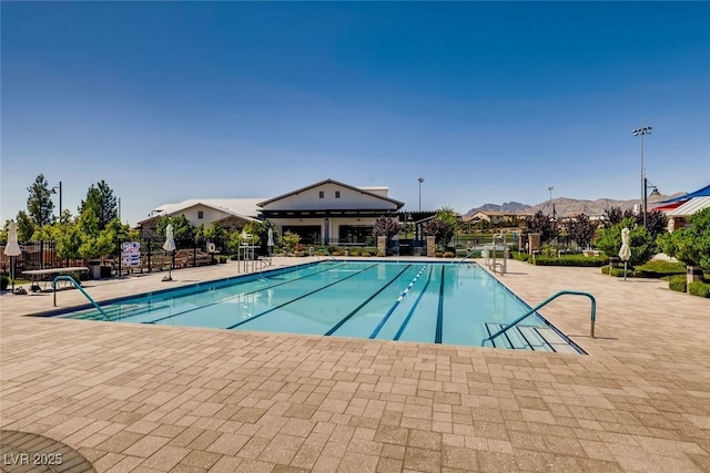 community pool featuring fence and a patio