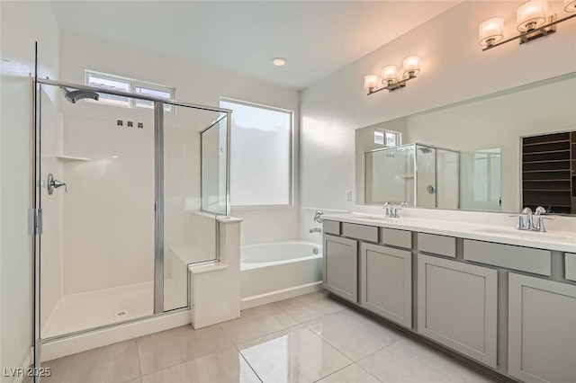 bathroom with double vanity, tile patterned floors, a sink, a shower stall, and a bath