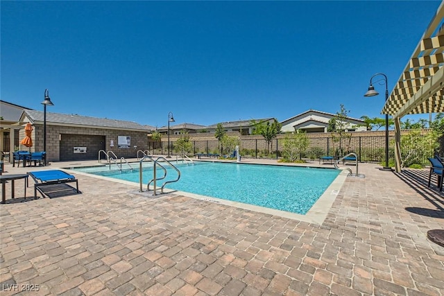 pool with fence and a patio