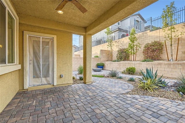 view of patio / terrace featuring ceiling fan and fence