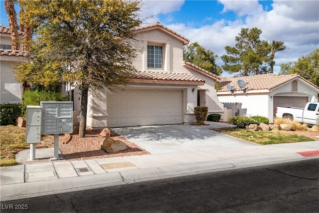 mediterranean / spanish-style home with driveway, stucco siding, and a tiled roof