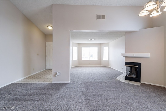 unfurnished living room featuring carpet, visible vents, baseboards, and a multi sided fireplace