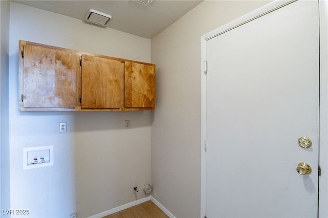 laundry room with baseboards, hookup for a washing machine, cabinet space, and hookup for a gas dryer