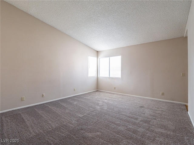 carpeted spare room with baseboards and a textured ceiling