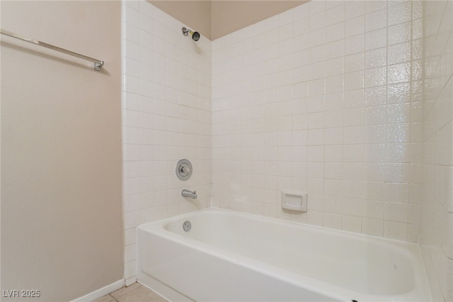 bathroom with baseboards, tub / shower combination, and tile patterned floors