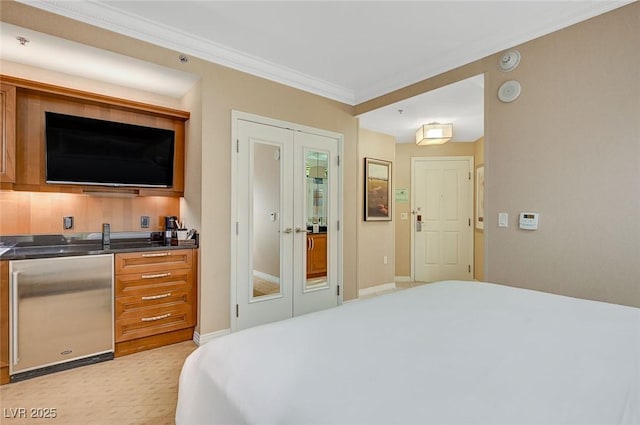 bedroom with ornamental molding, french doors, baseboards, and refrigerator