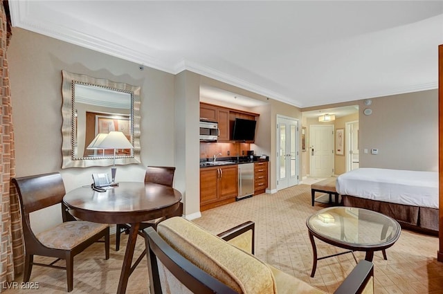 interior space with ornamental molding and baseboards