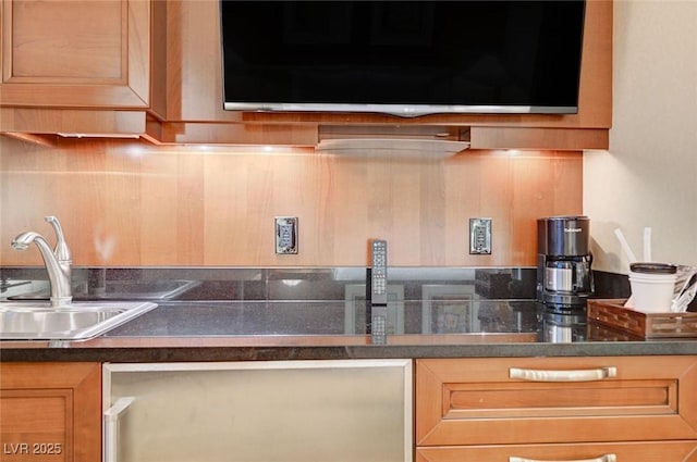 kitchen with dark countertops and a sink