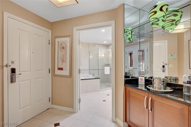 full bath featuring vanity, french doors, a shower stall, a bath, and tile patterned floors