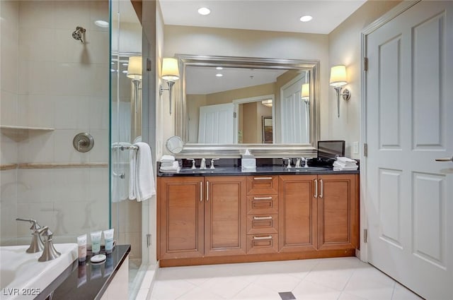 bathroom with a stall shower, a sink, recessed lighting, and double vanity