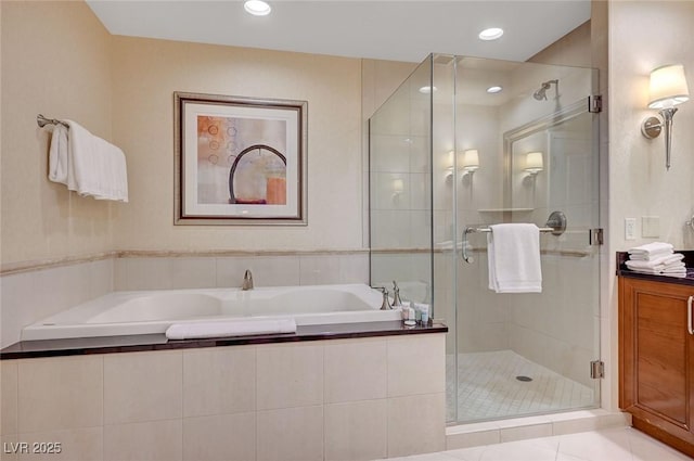 bathroom with tile patterned flooring, a garden tub, a shower stall, and recessed lighting