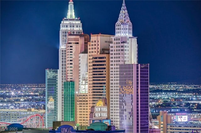 property at night featuring a view of city lights