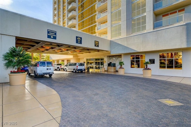 exterior space featuring covered parking and stucco siding