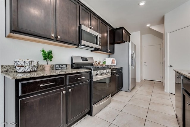 kitchen featuring light stone counters, light tile patterned flooring, recessed lighting, dark brown cabinets, and appliances with stainless steel finishes