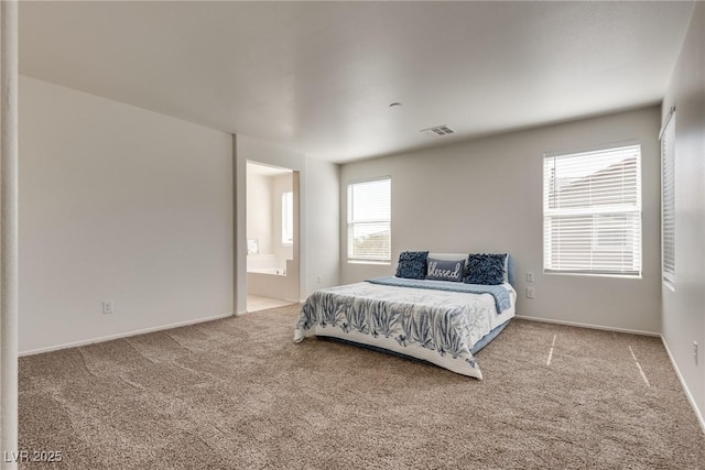 bedroom featuring ensuite bath, carpet flooring, visible vents, and baseboards