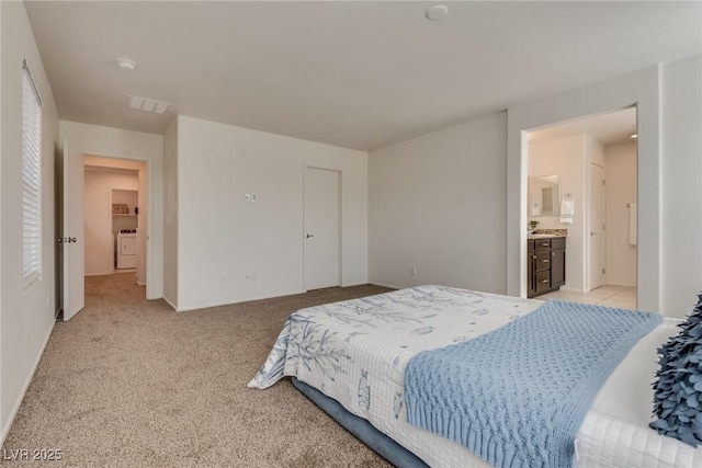 bedroom featuring light colored carpet, visible vents, and baseboards