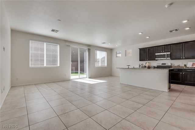 kitchen with light tile patterned floors, recessed lighting, stainless steel appliances, visible vents, and open floor plan