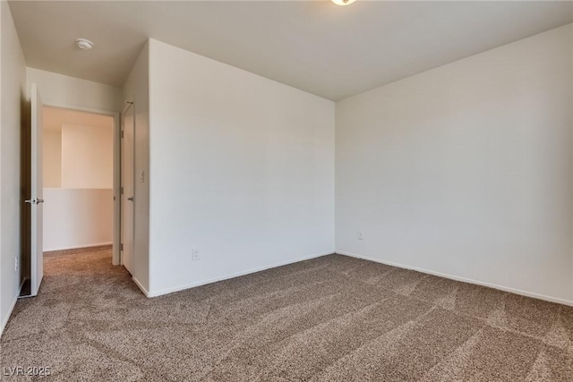 carpeted spare room with baseboards