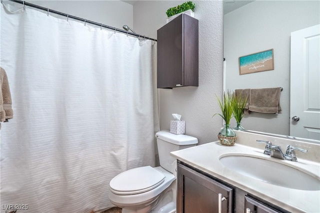 bathroom featuring a shower with curtain, toilet, and vanity