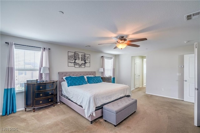 bedroom featuring visible vents, light carpet, and baseboards