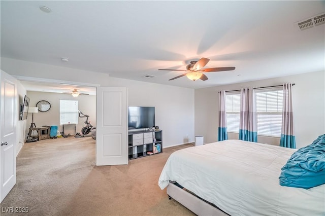 bedroom featuring visible vents, light carpet, and ceiling fan