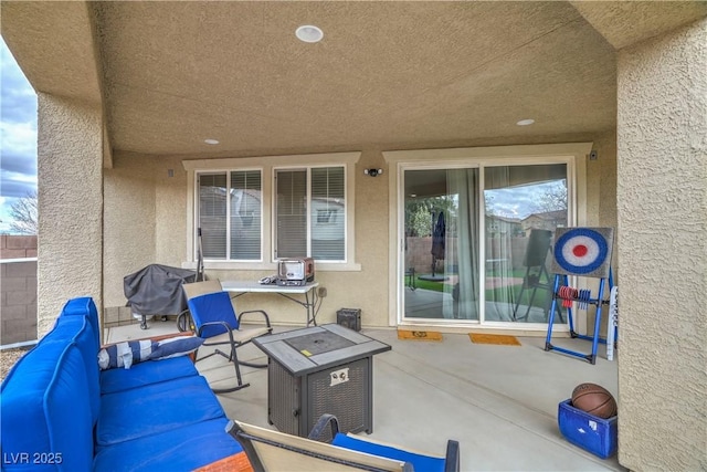 view of patio / terrace with an outdoor living space with a fire pit and area for grilling