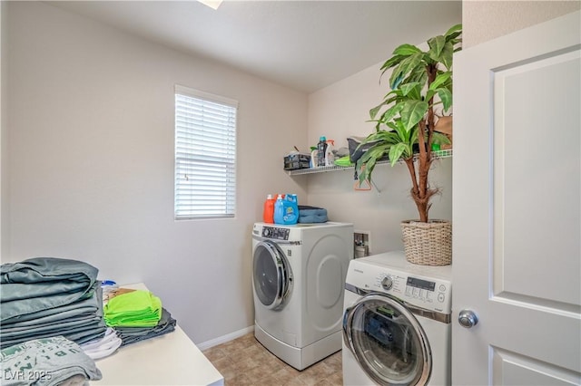 laundry room with laundry area, baseboards, and washer and clothes dryer