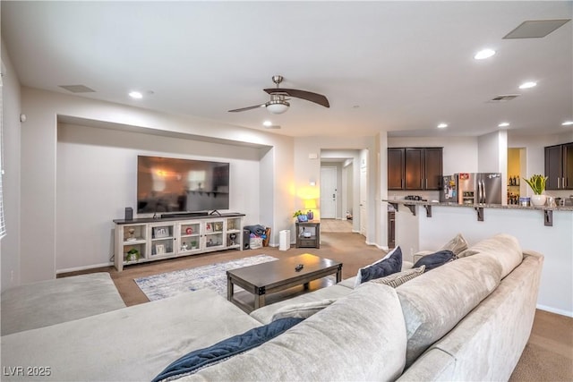 living area featuring visible vents, a ceiling fan, recessed lighting, carpet floors, and baseboards