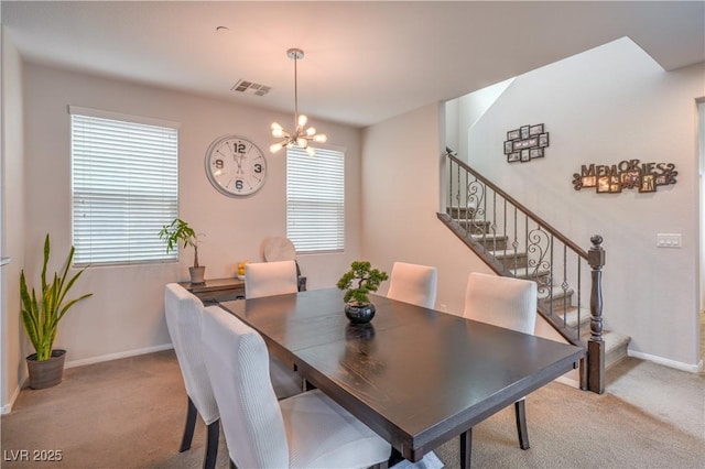 dining space featuring stairway, visible vents, a chandelier, and light carpet