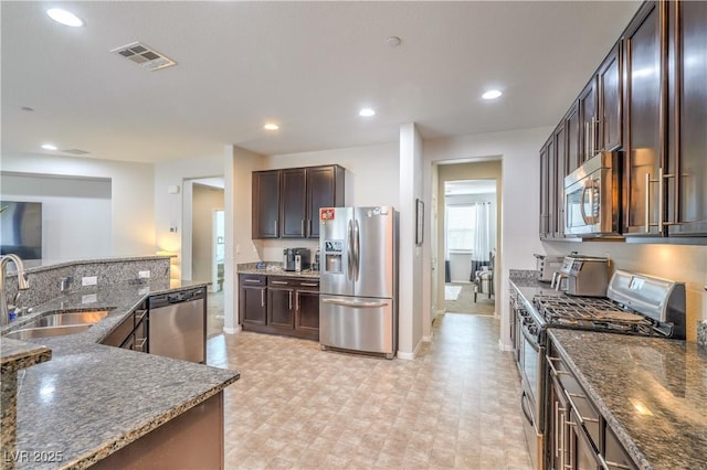 kitchen with visible vents, dark brown cabinetry, recessed lighting, appliances with stainless steel finishes, and a sink