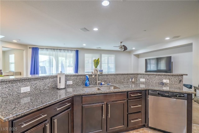 kitchen featuring dark brown cabinetry, a sink, a wealth of natural light, and stainless steel dishwasher