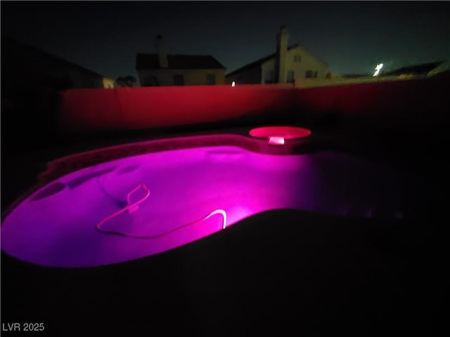 view of pool at night