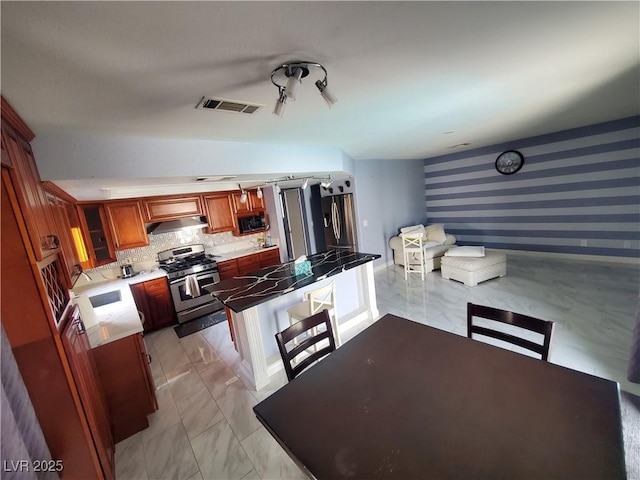 kitchen featuring marble finish floor, visible vents, gas range, under cabinet range hood, and wallpapered walls